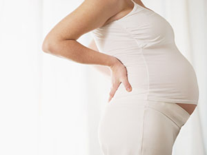 Pregnant patient receiving chiropractic care at HealthMax Chiropractic of Hudson